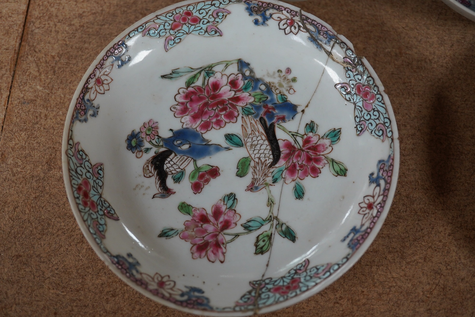 A Chinese porcelain famille rose 'double pheasant' tea bowl and saucer and a Mandarin pattern coffee cup and saucer, all Qianlong period, largest 11.5cm diameter. Condition - one saucer broken, others fair to good